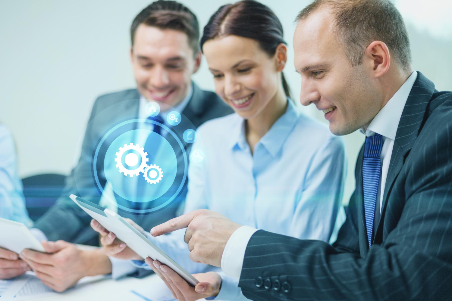 business-technology-and-people-concept-smiling-business-team-with-tablet-pc-computer-virtual-settings-projection-having-discussion-in-office